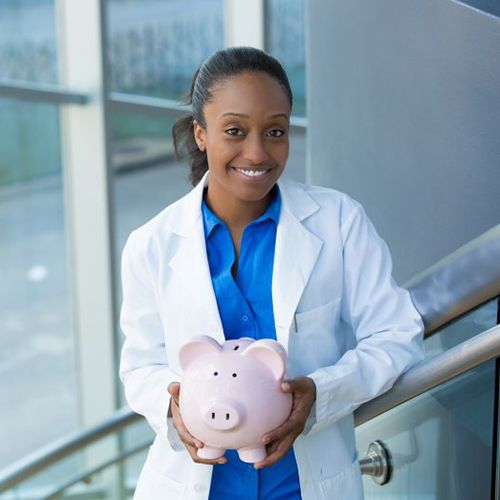 dentist holding a pink piggy bank 