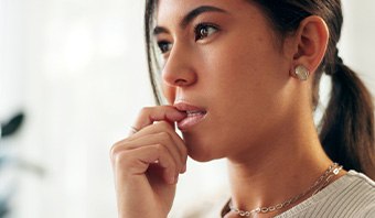 Closeup of woman biting her nails