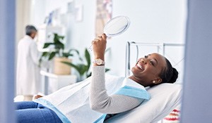 Woman smiling while looking at reflection in mirror