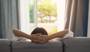 Back of head of woman resting on couch 