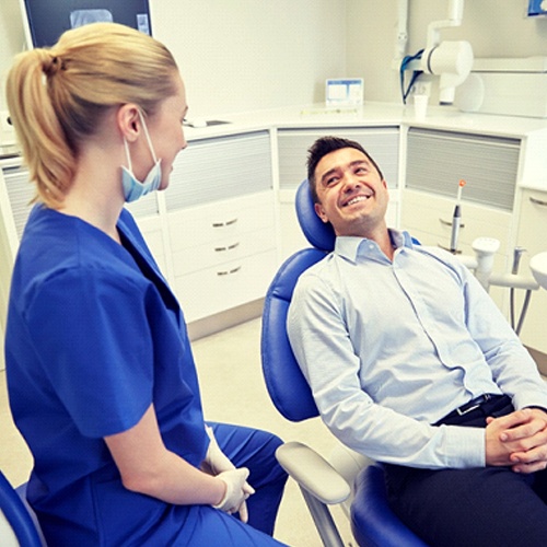dental patient smiling at his dentist