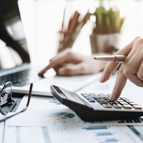 Patient using a calculator and laptop 