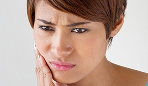 Woman holding jaw