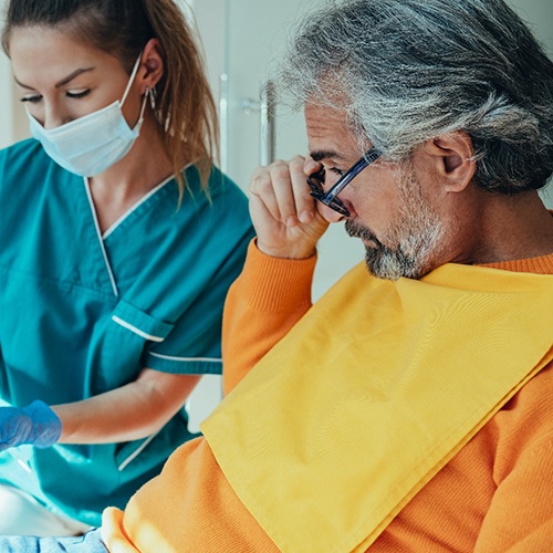 a dentist in Indian Land explaining how implant dentures work