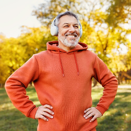 a man in Indian Land smiling with implant dentures 