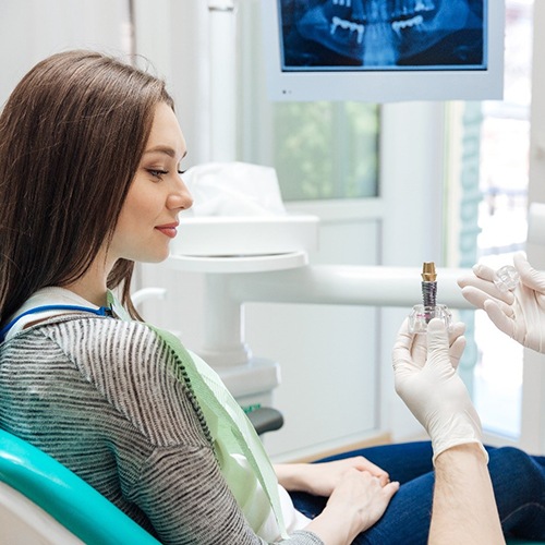 Dentist talking to patient about dental implants