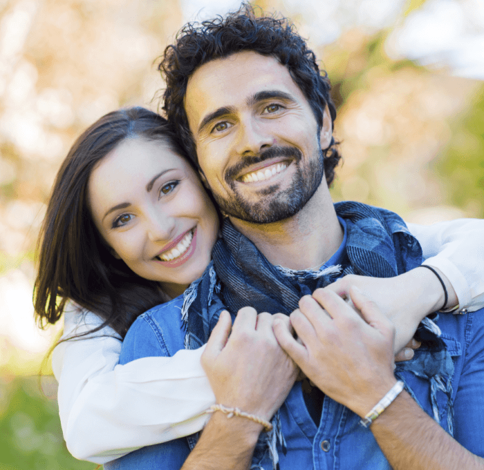 Man and woman smiling outdoors