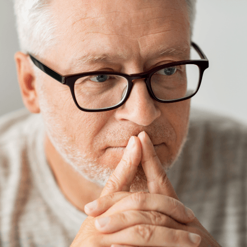 Man in glasses contemplating choices
