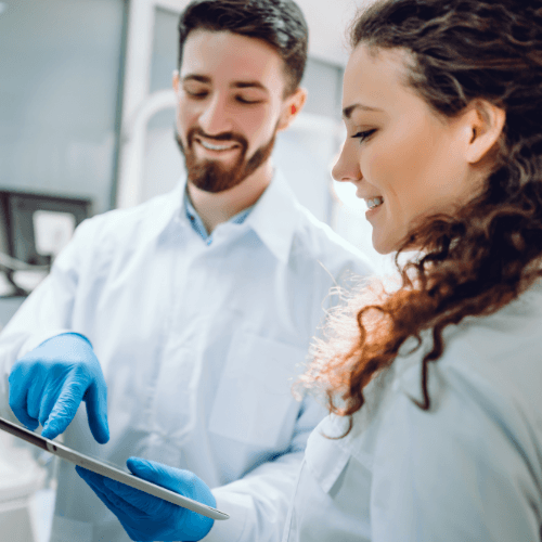 Dentist and patient looking at tablet computer