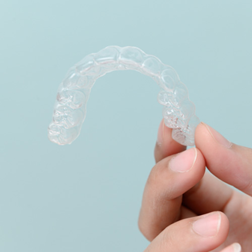 Patient holding clear aligner