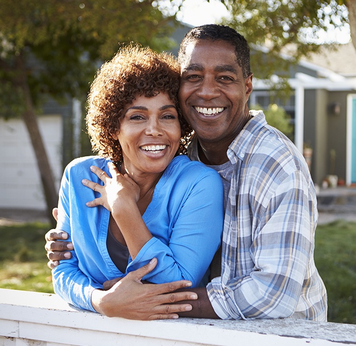 Older man and woman smiling outdoors