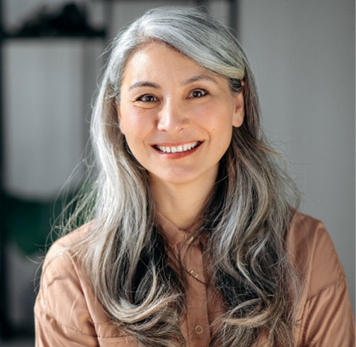 woman with long gray hair smiling 