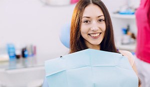 Red haired female dental patient smiling