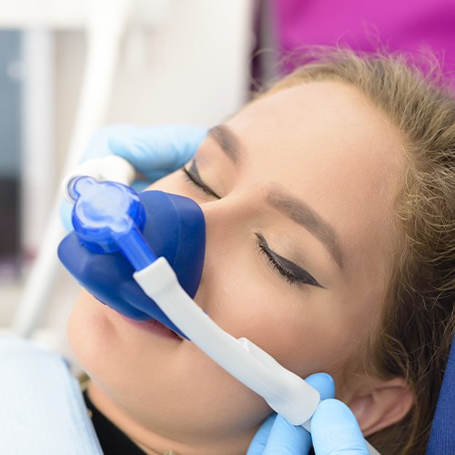 Woman with nitrous oxide nose mask