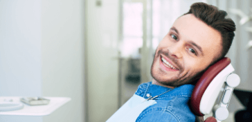 Man in dental chair smiling