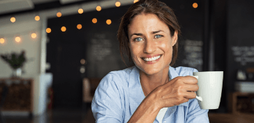 Smiling woman holding a cup of coffee