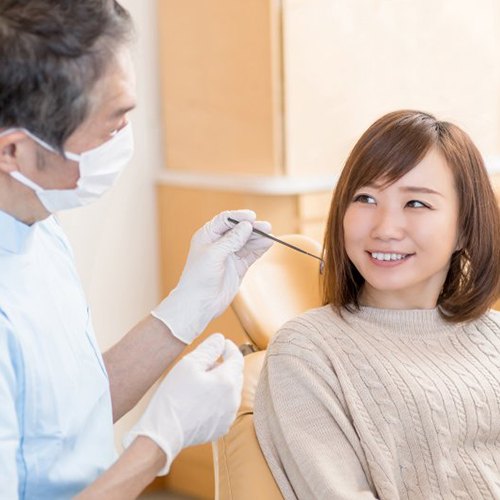 woman discussing treatment options with her dentist 