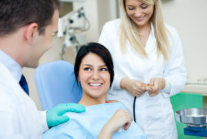 Dentist talking with female patient about root canal therapy