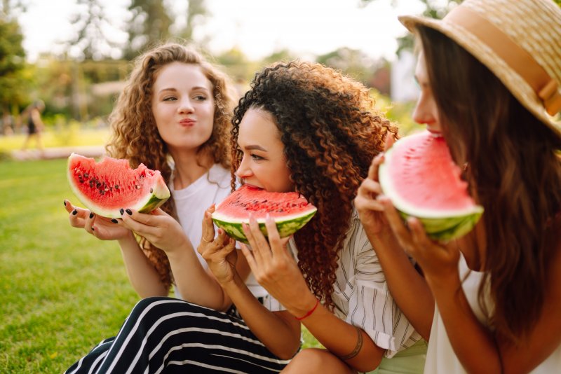 group of friends eating watermelon