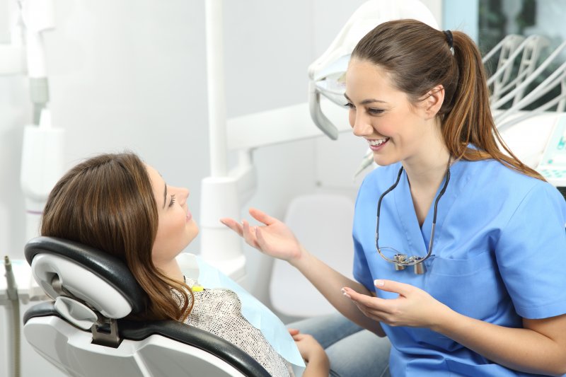 patient smiling while talking to dentist 