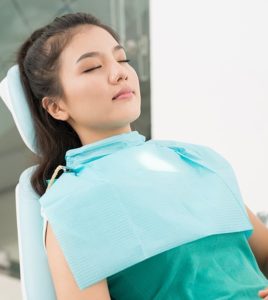 Relaxed young woman in dentist’s chair