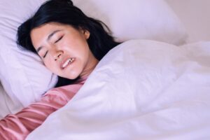 Woman grinding her teeth in her sleep.