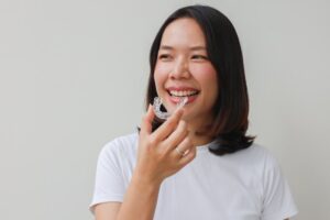Woman putting on her top Invisalign tray